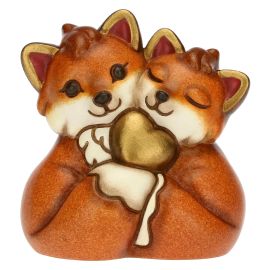 Fox couple with golden heart